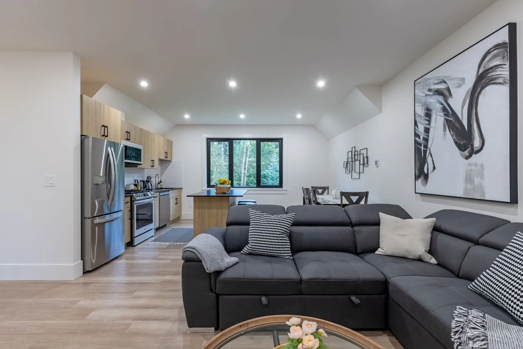 The open living area and kitchen of a two-bedroom coach house in Langley.