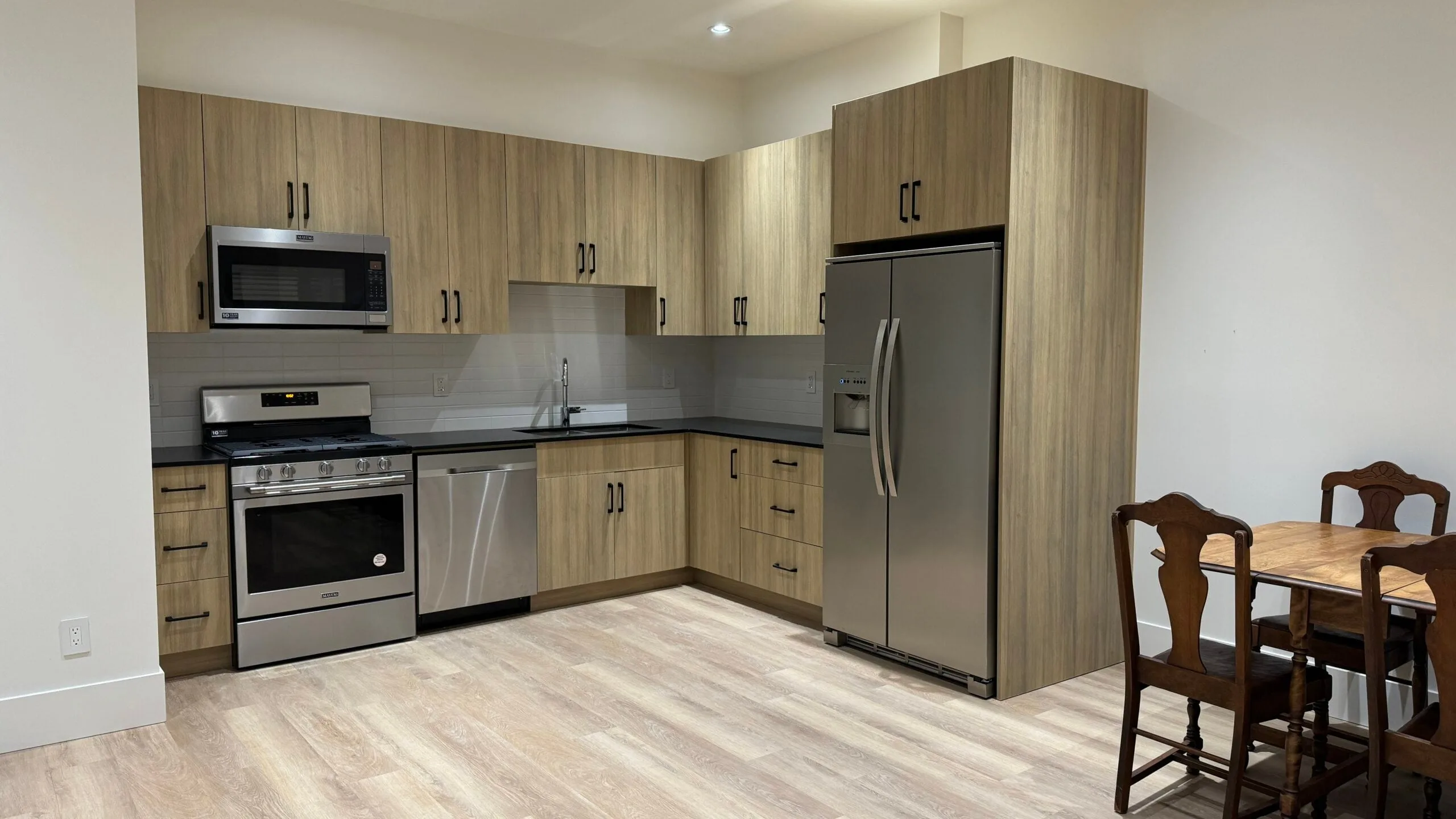 The suite kitchen, with wood-look cabinets and stainless appliances.