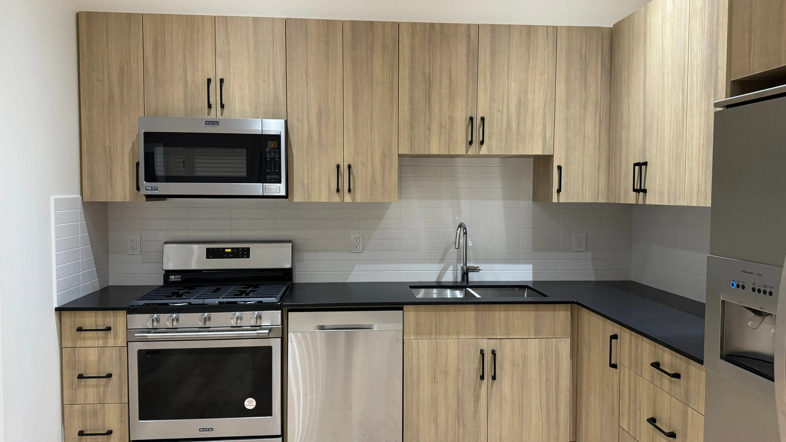 The kitchen elevation, with black counters and a subway tile backsplash.