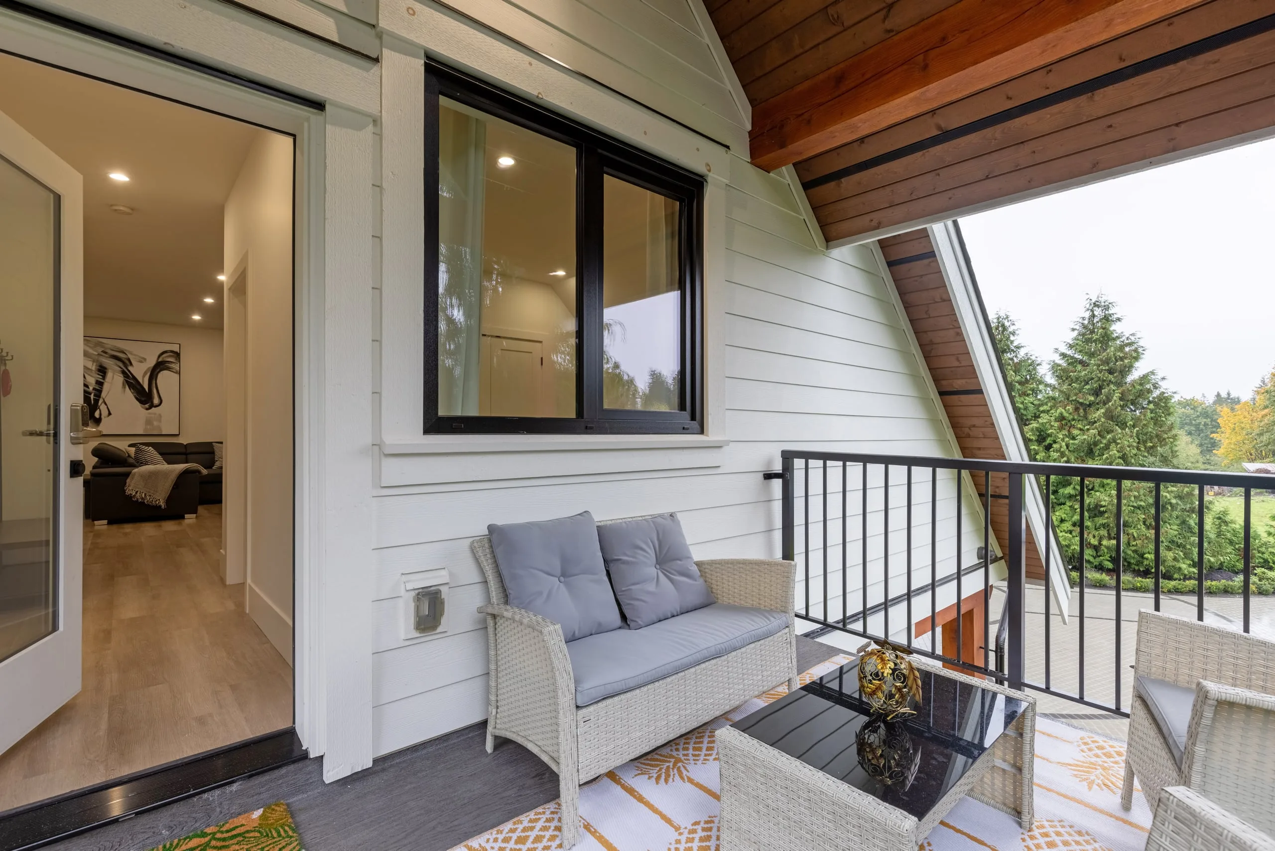 The covered balcony and private entry of the two-bedroom coach house ProStyle built over a garage in Langley.