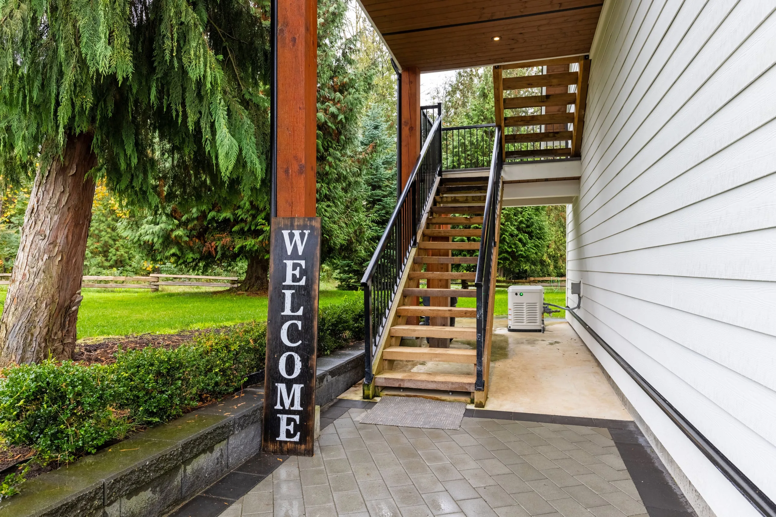The private exterior stair up to the garage-top coach house in Langley.