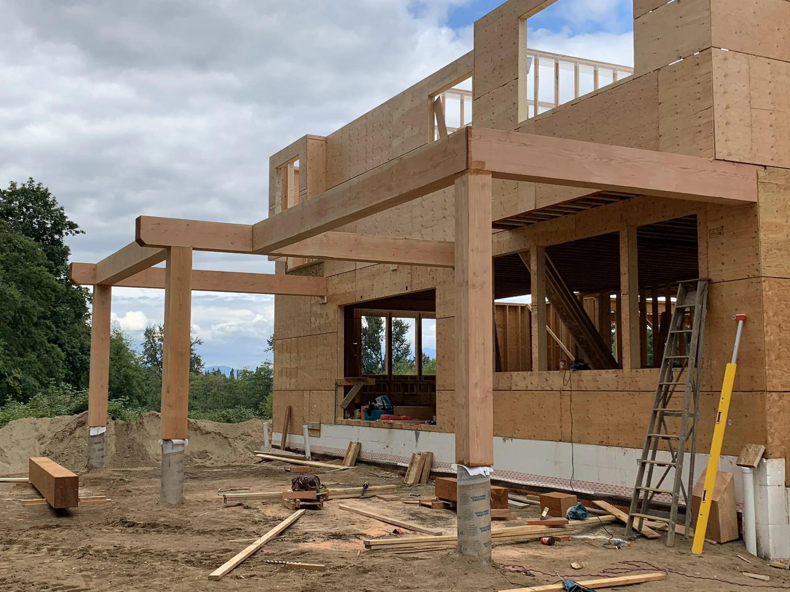 The Modern Country Estate in Langley during construction, with heavy timber posts and sheathing on the frame.